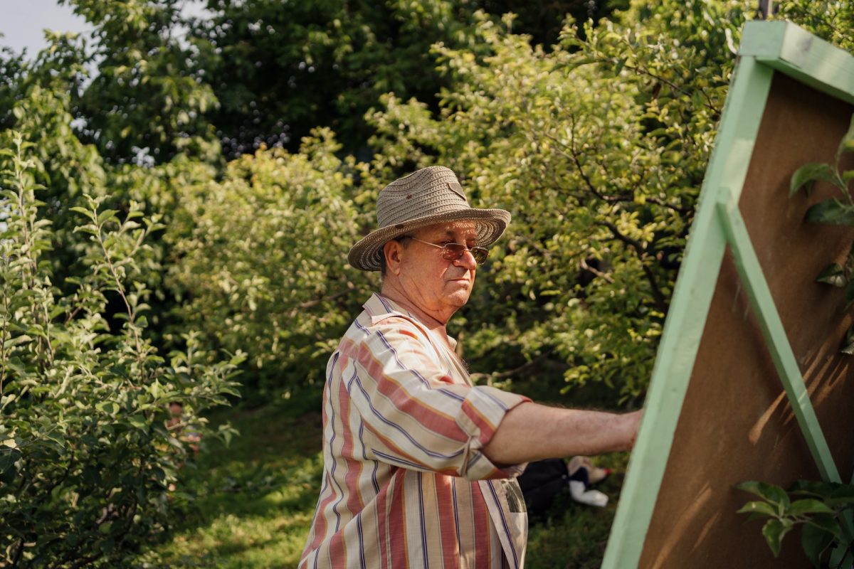 Senior man painting in his garden